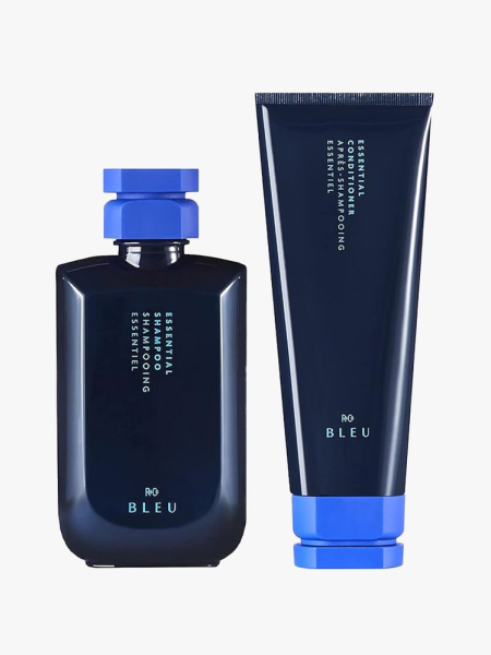 R+Co Bleu Essential Shampoo + Conditioner in branded components on a light gray background