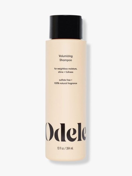Odele Volumizing Shampoo yellow bottle on light gray background